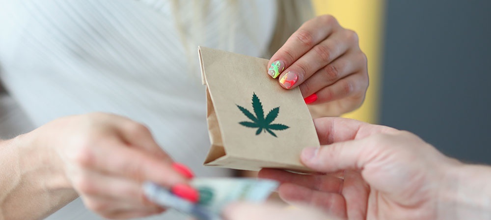 Woman receiving her online weed order in a bag