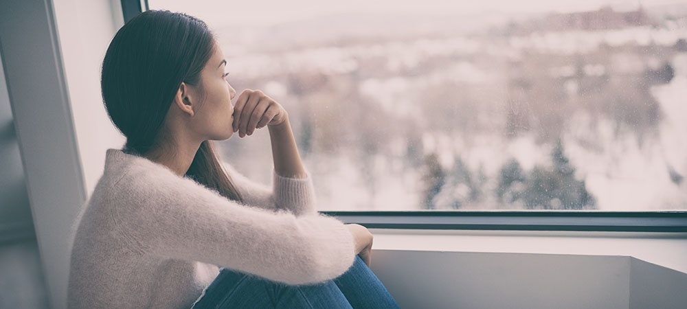 Woman sitting by the window