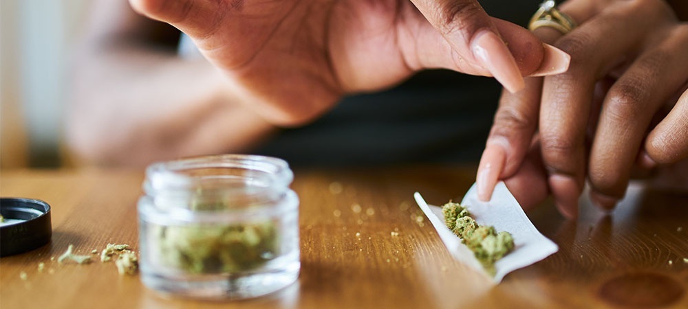 Woman rolling weed joint