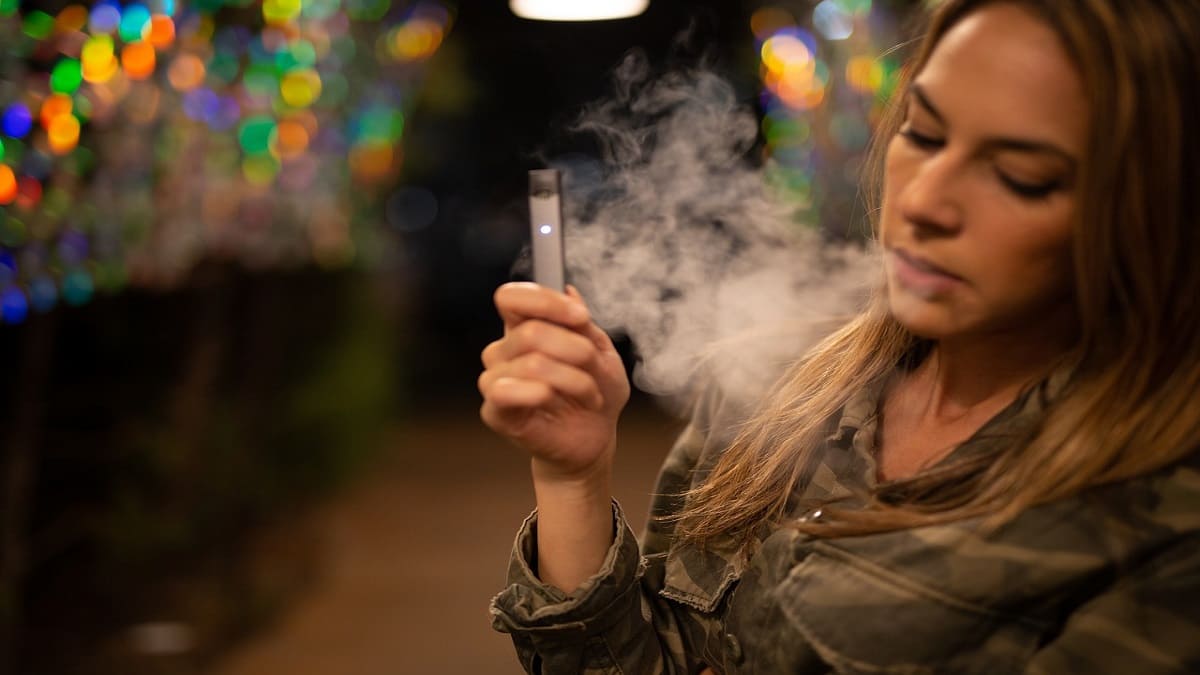 Woman smoking a disposable weed pen